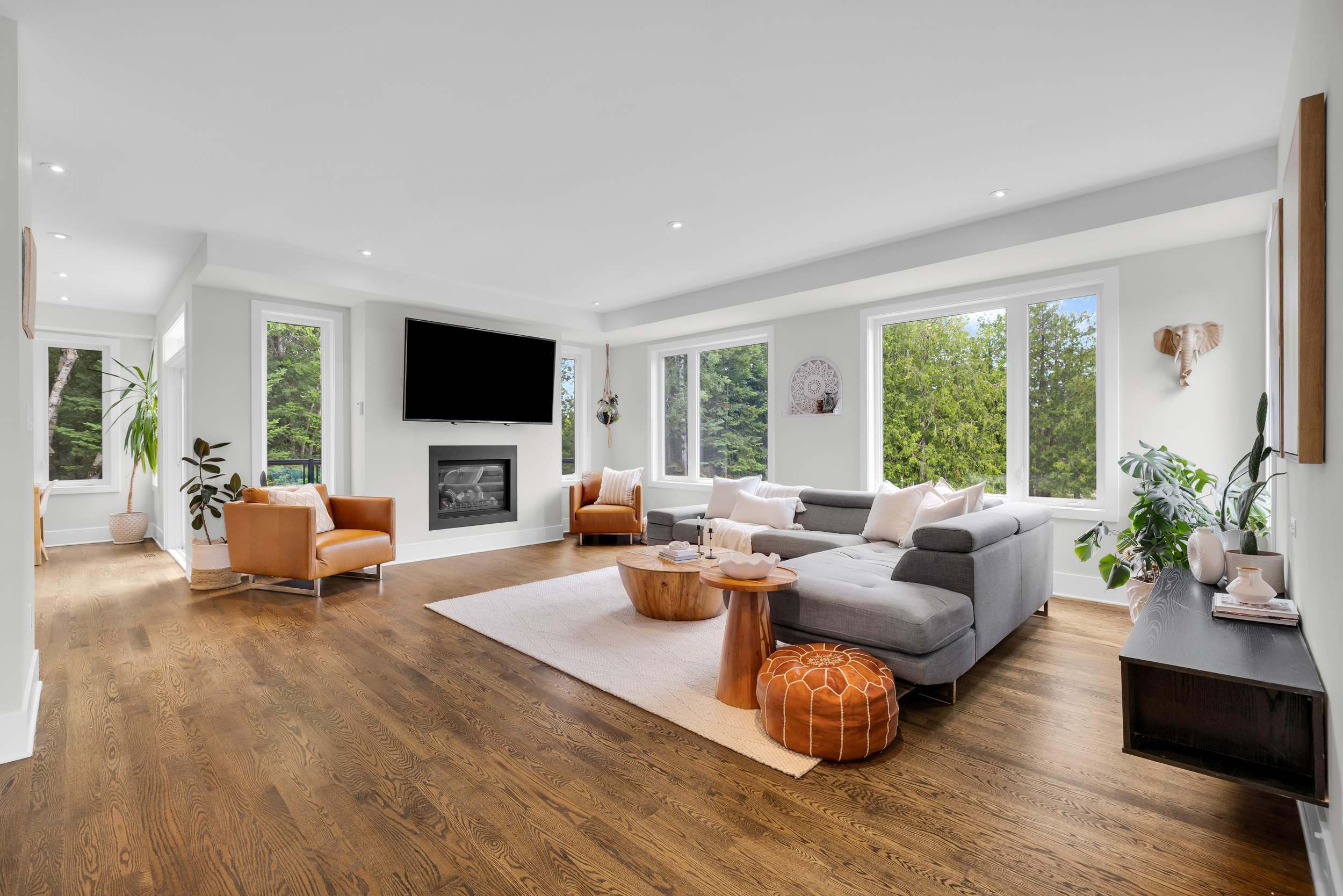 Bright living room with fireplace and tall ceilings