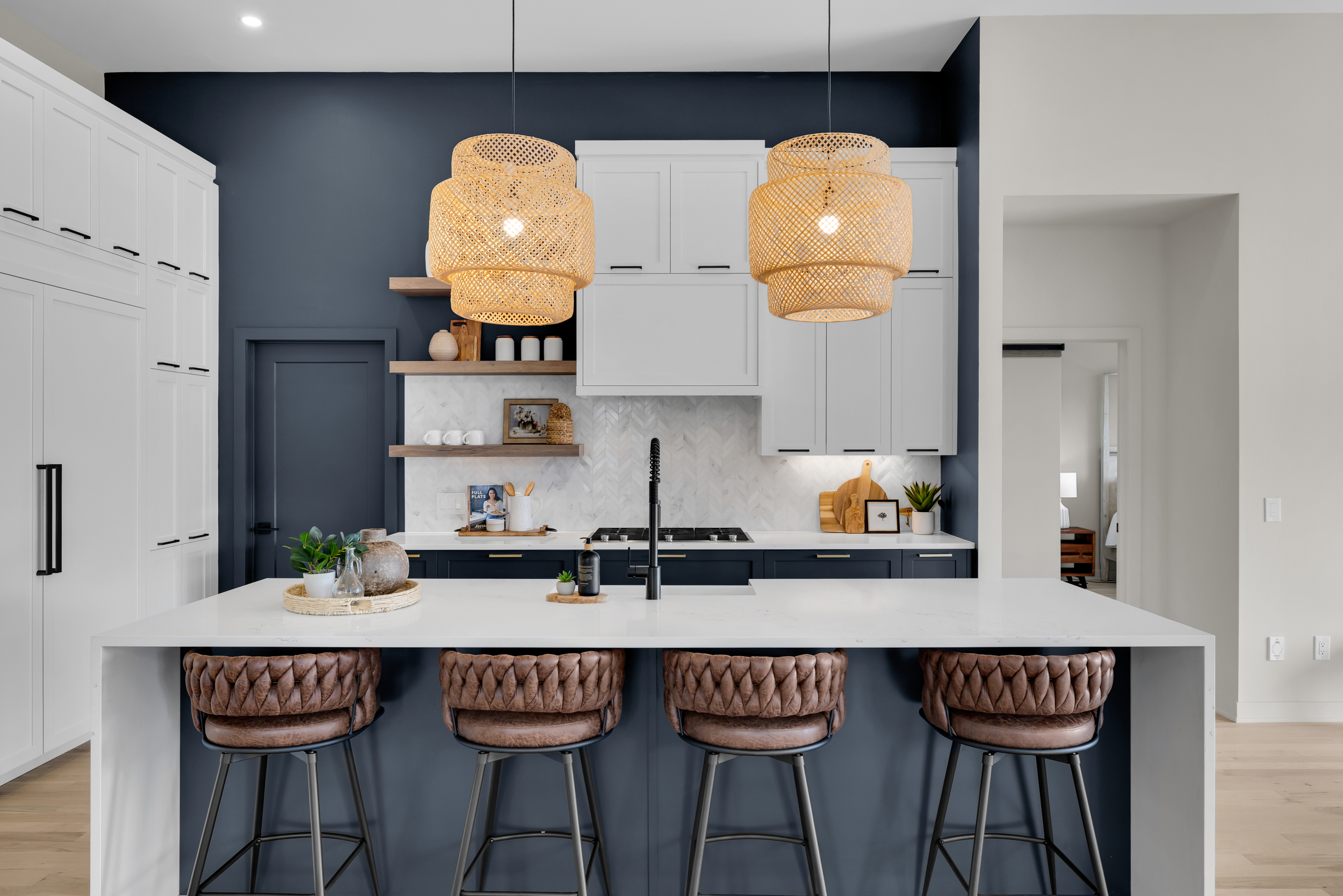 Navy blue kitchen with rattan pendant lighting
