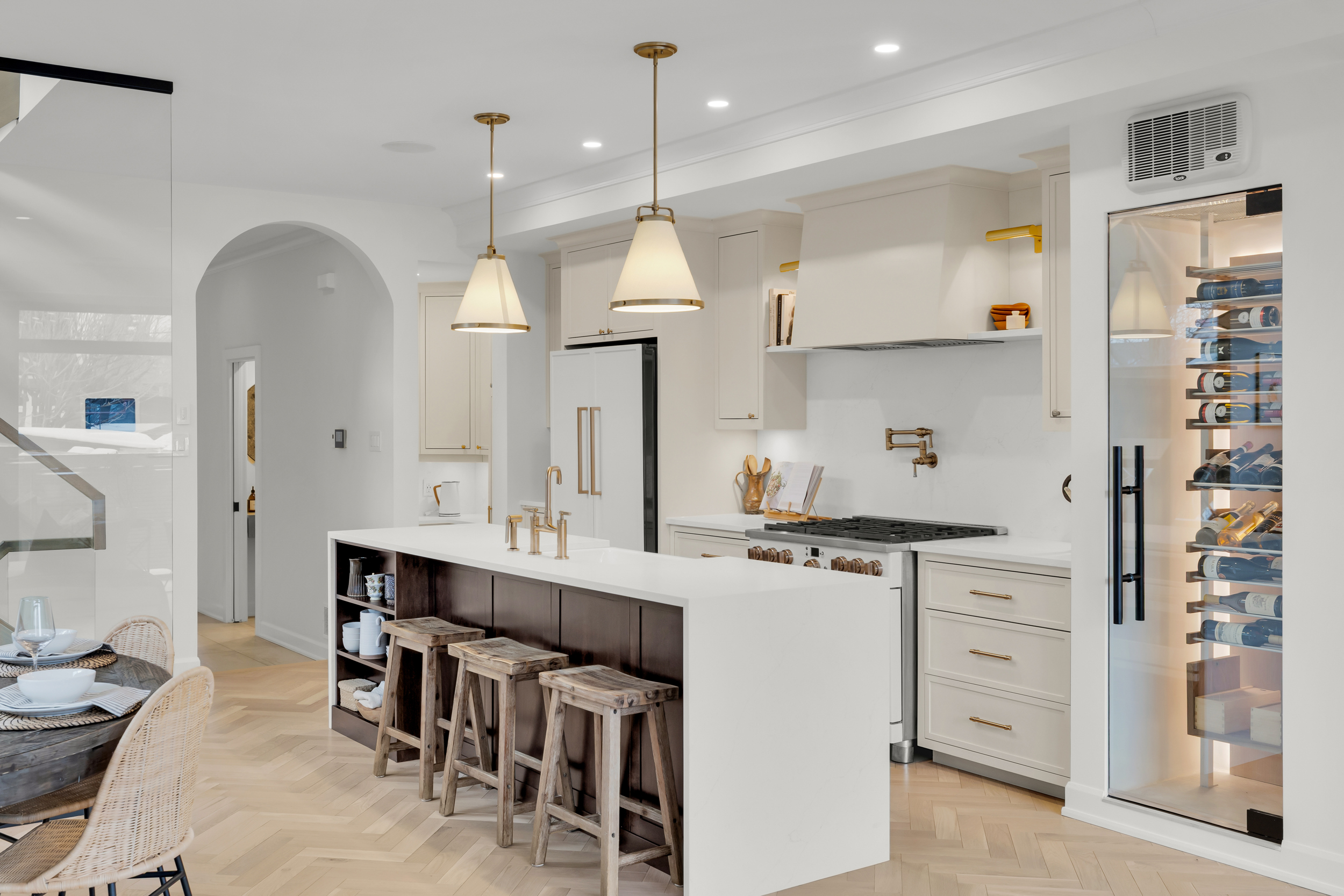 Custom kitchen with gold fixtures and wine cellar