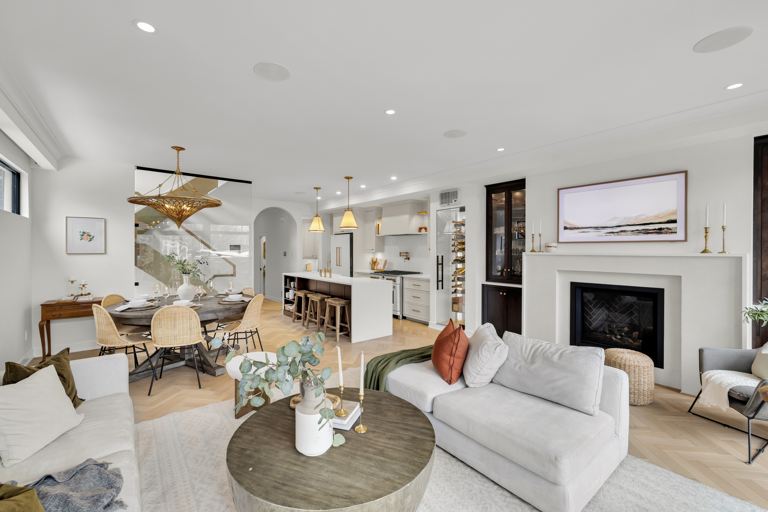 Luxury living and dining area with herringbone floors